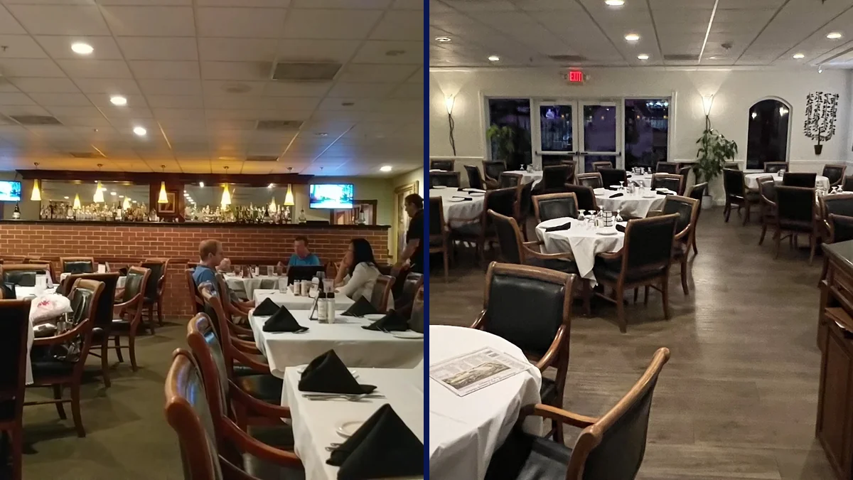 Set tables beside a polished bar and wine display.
